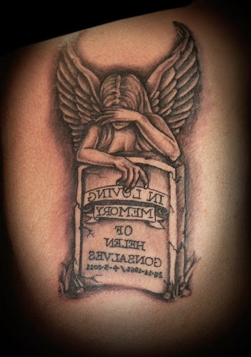 Angel crying over tombstone tattoo