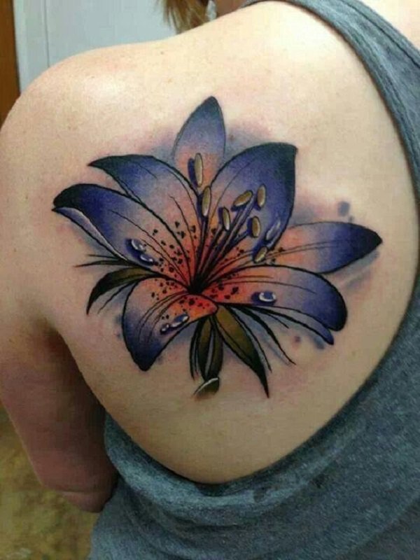 Dark-blue-watercolor-lily-tattoo-on-shoulder-blade