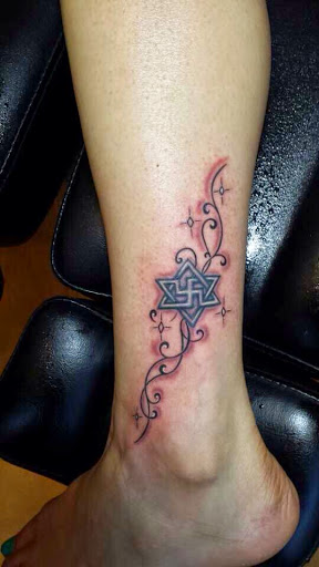 Geometric Star tattoo designs in tribal style on ankle for men and women.
