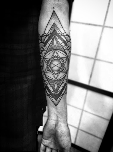 Geometric Star tattoo designs on arm ideas for guys.