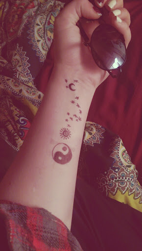 Small Stars, moon, sun and yim yang tattoos ideas for women on wrist.