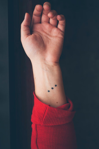 Small Stars tattoo looks cute on wrist.