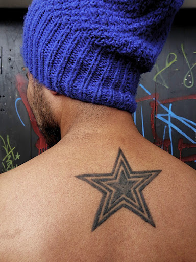 Upper back nautical Star tattoos for men.